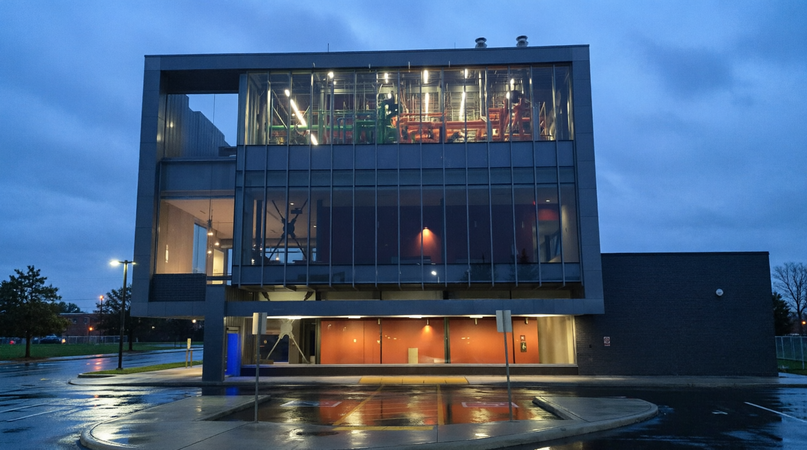 Mid-rise building under construction with glass curtain wall and boom lifts